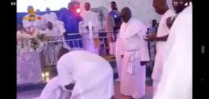 Israel Oladele prostrating to Easily Ayinde Marshall at the Altar