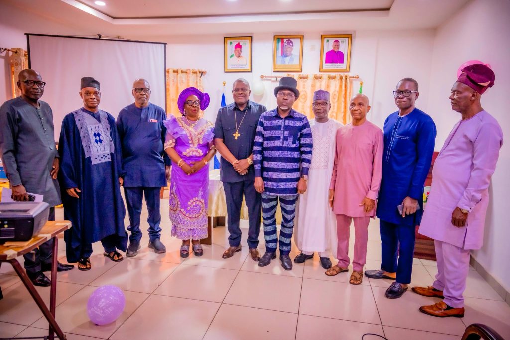 Barr. Sonny Ebiyaibo, a former Director of Administration and his wife, in a group photo with the ES, Bishop Stephen Adegbite, and other members of the Commission management.